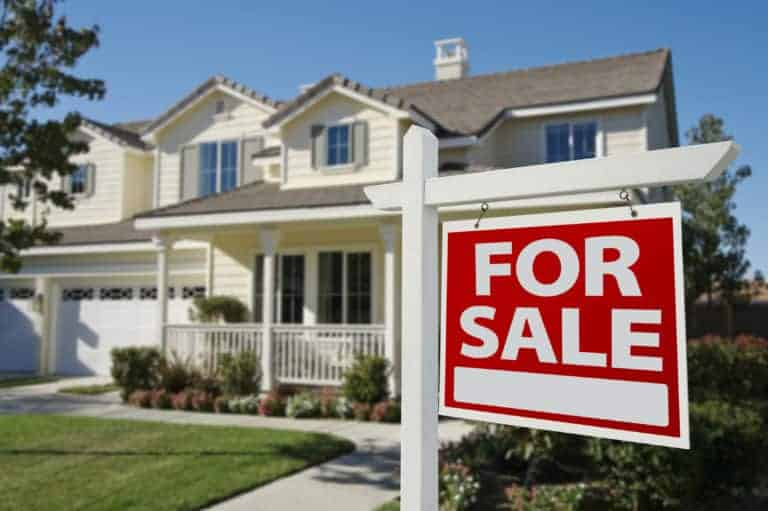 A house with a for sale sign in front, indicating the need for repairs before listing.