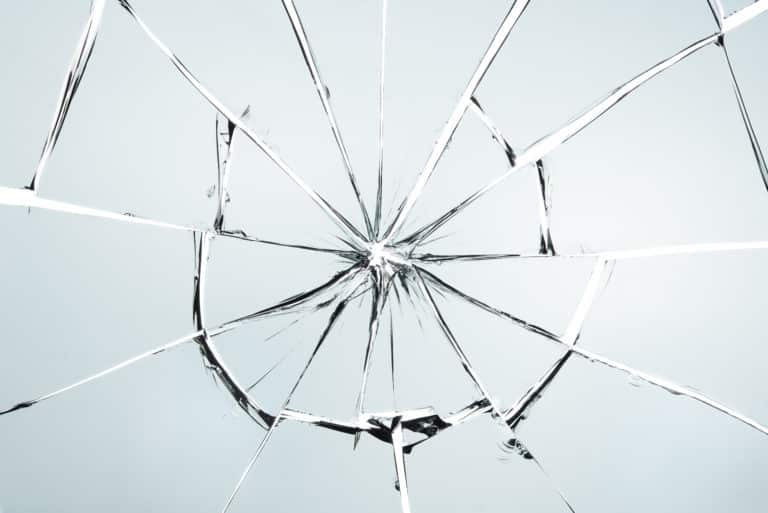 A shattered glass on a white background.
