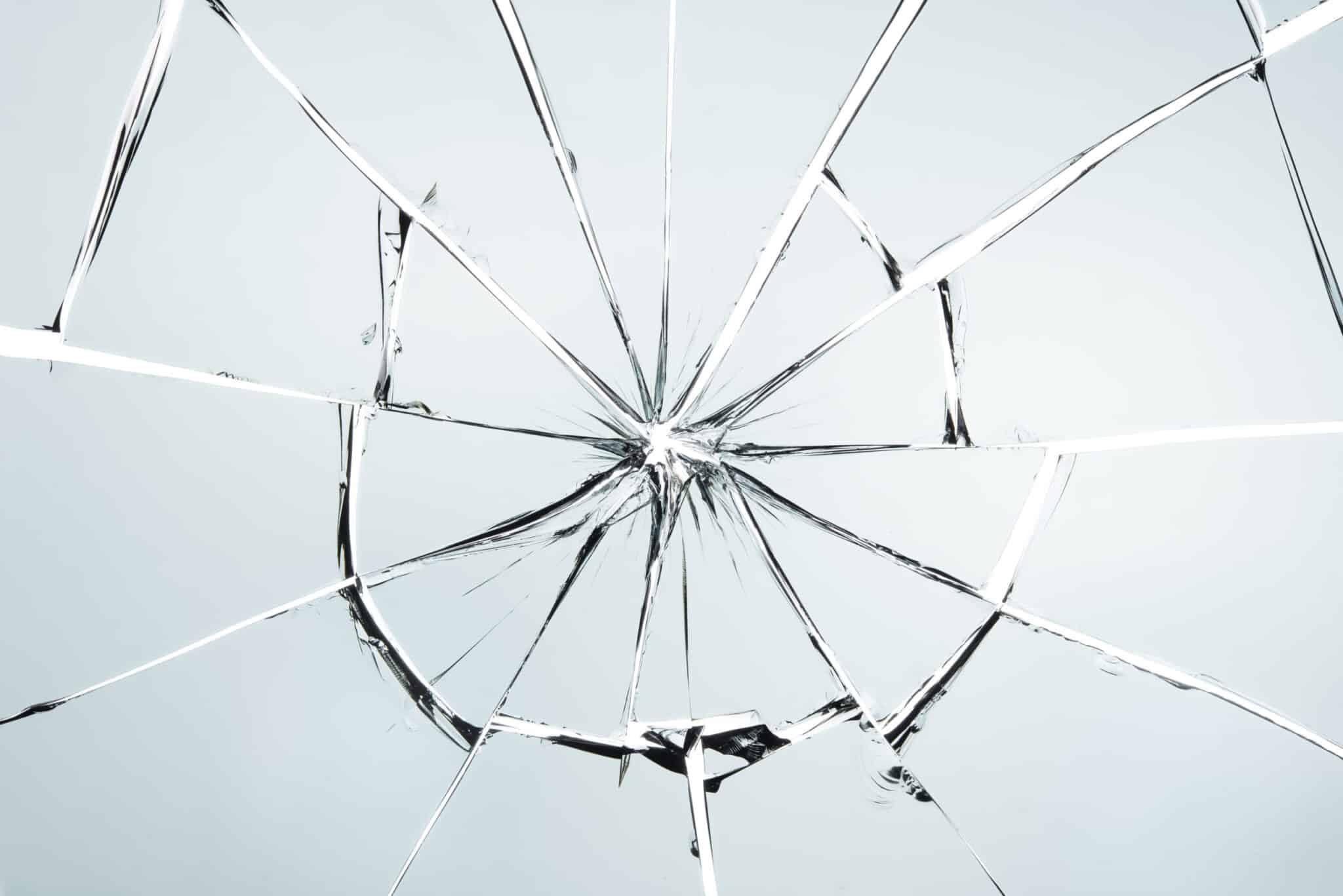 A shattered glass on a white background.