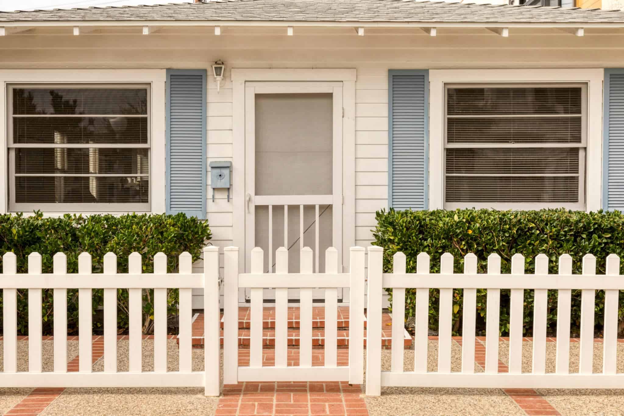 Window and door screens on a cute house.