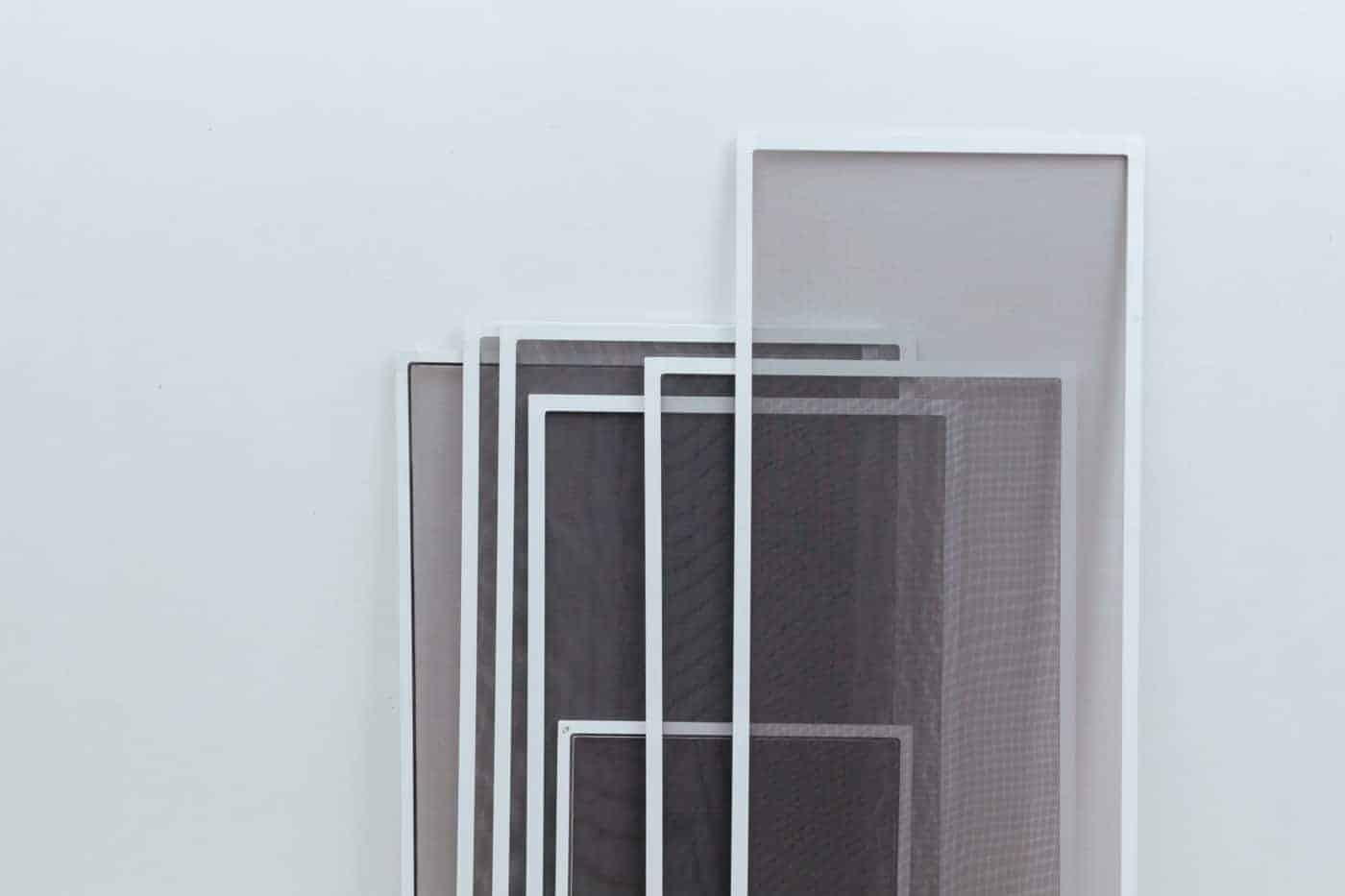 A white wall adorned with a stunning arrangement of black and white frames.