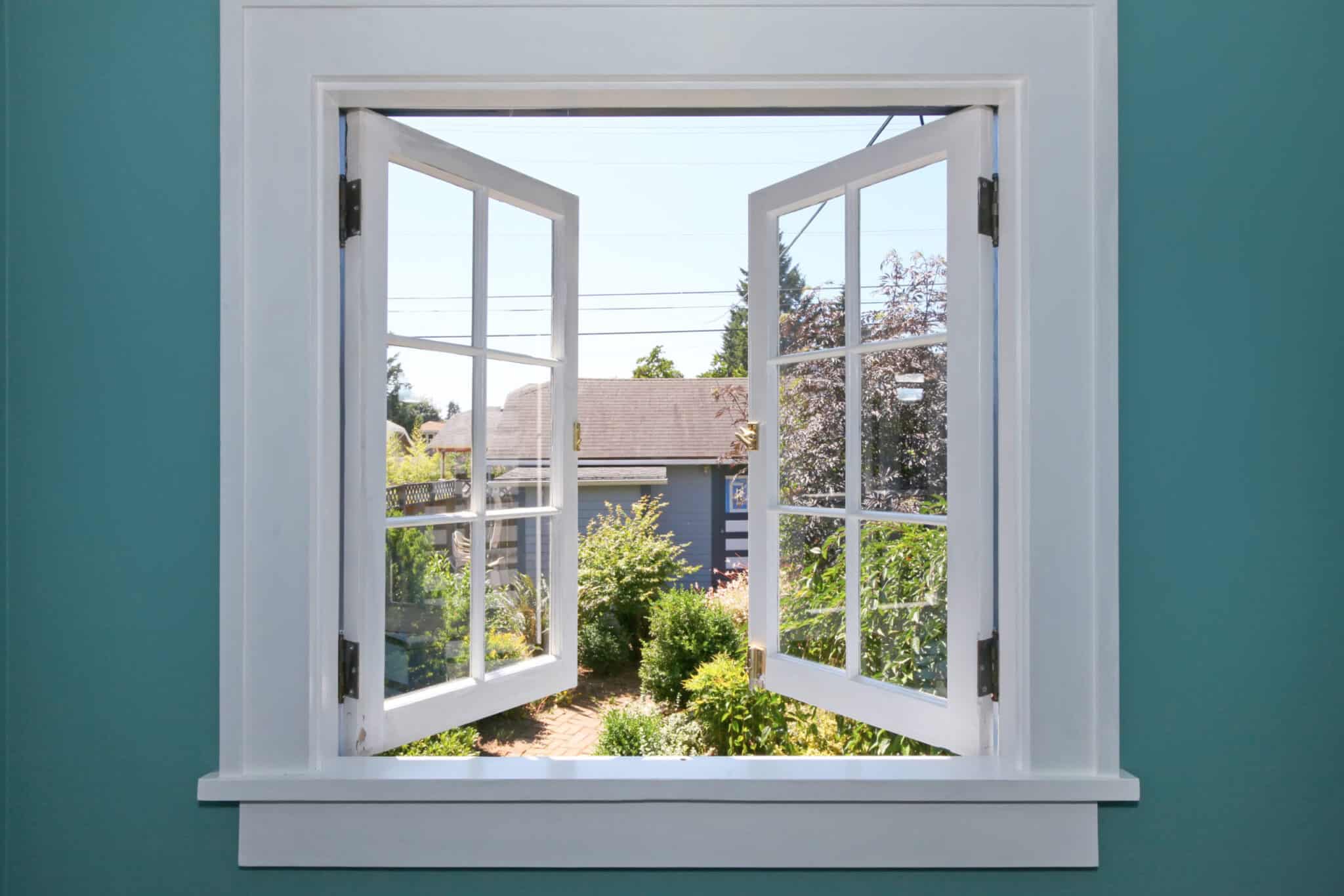 A casement window opening to the backyard