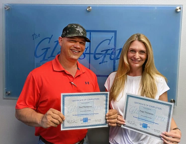 Paige and Paul Thompson receiving their certificate of completion