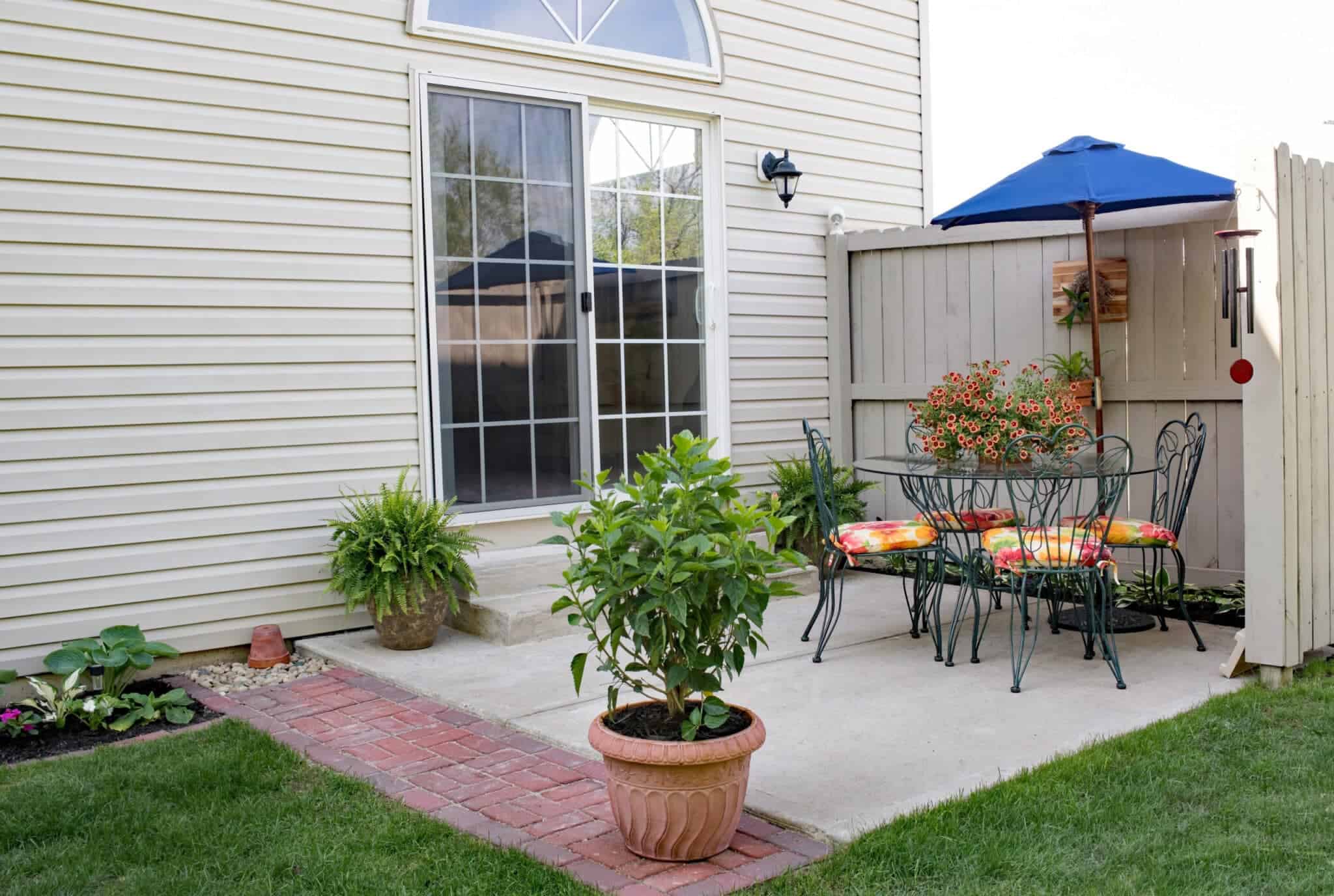 French sliding glass patio doors in a cute backyard.