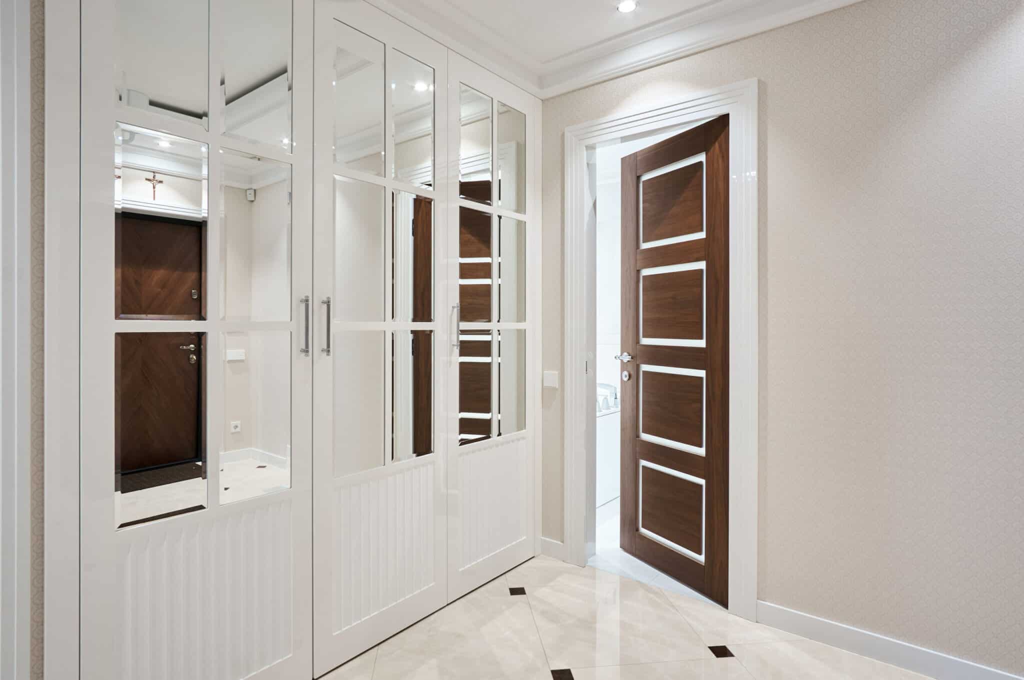 >Hallway closet doors with mirrored panels.