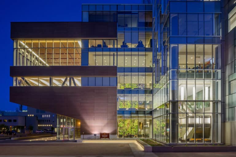The exterior of a glass building at night.