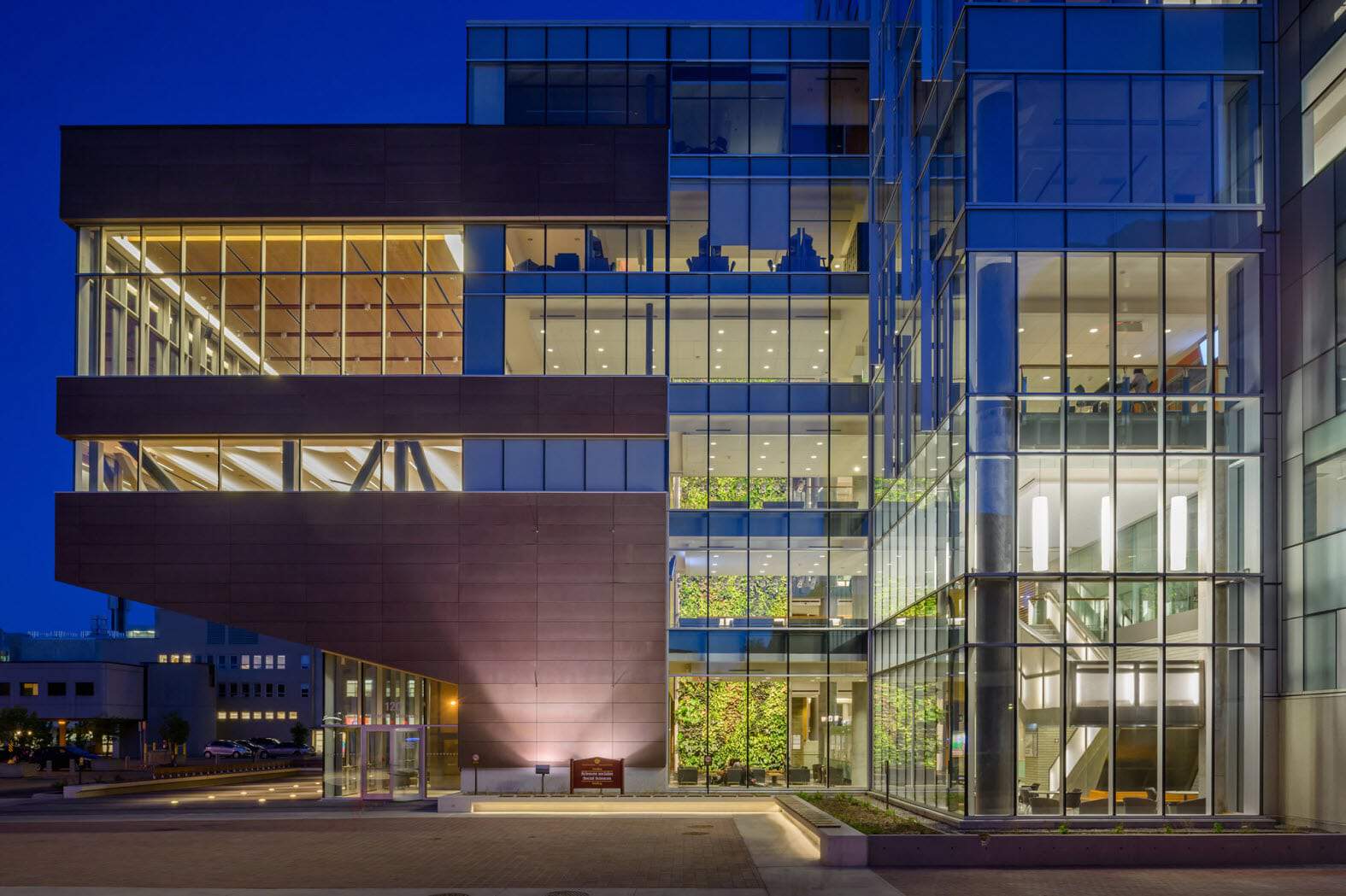 The exterior of a glass building at night.